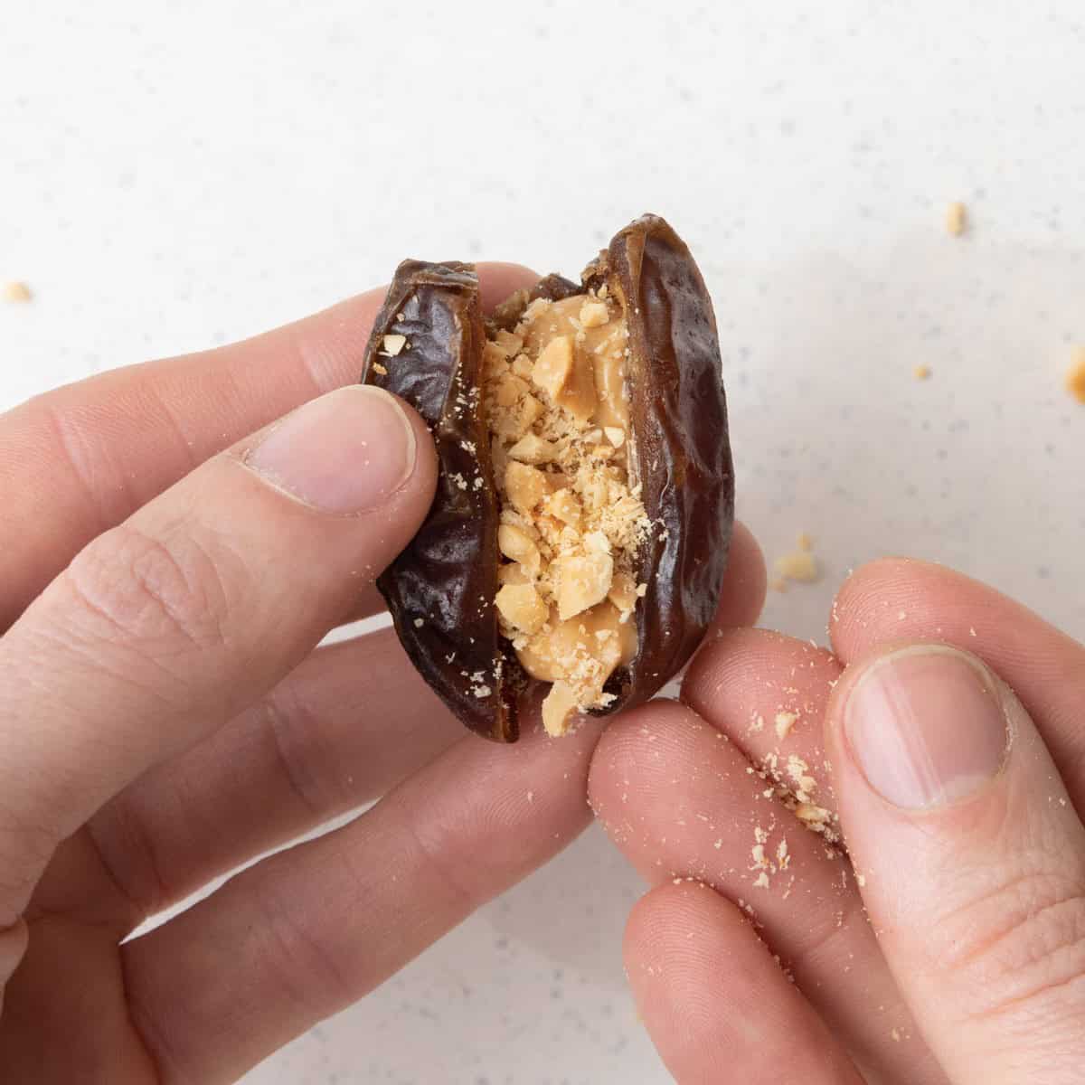 Add crushed peanuts into stuffed date.