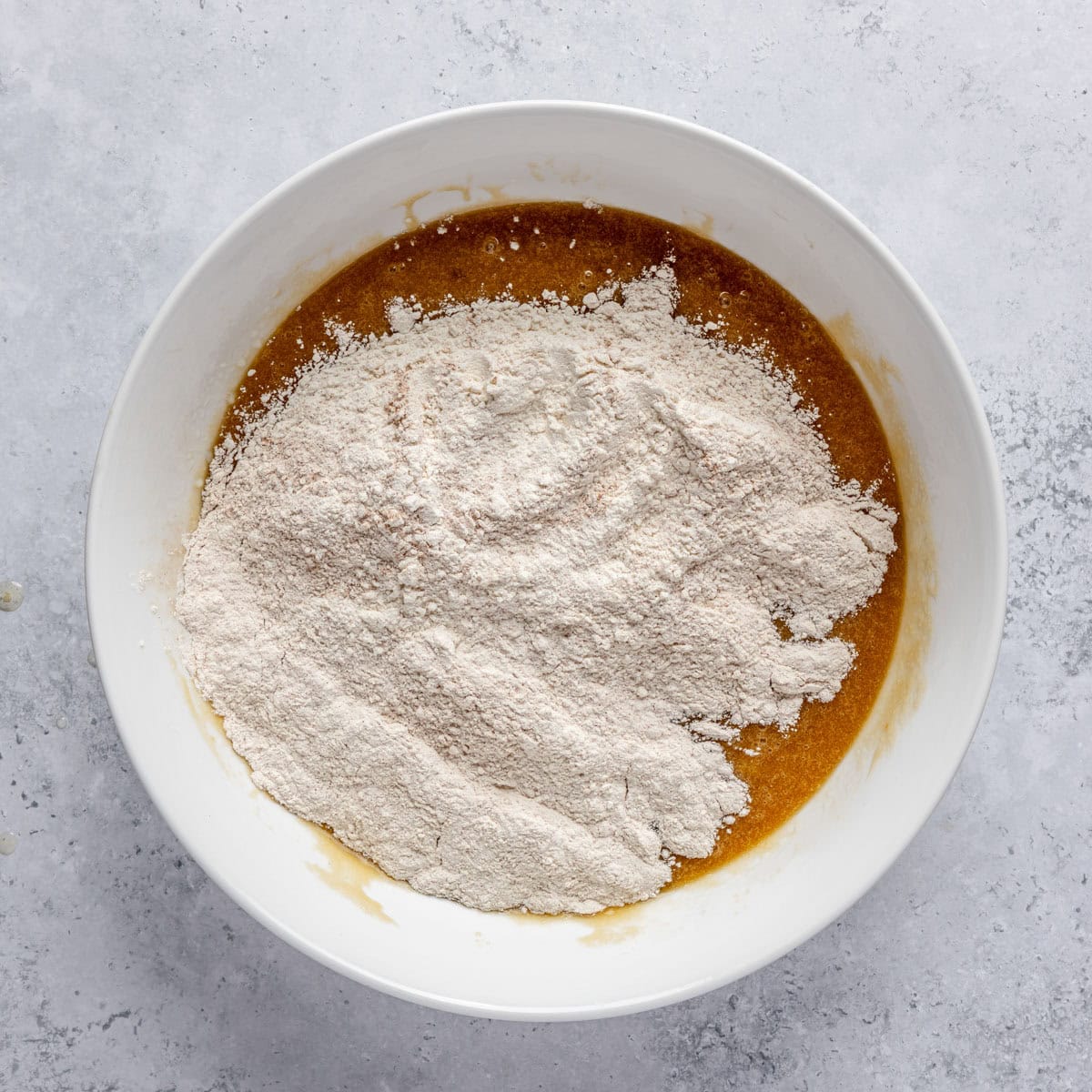 After combining wet ingredients with dry ingredients added on top.