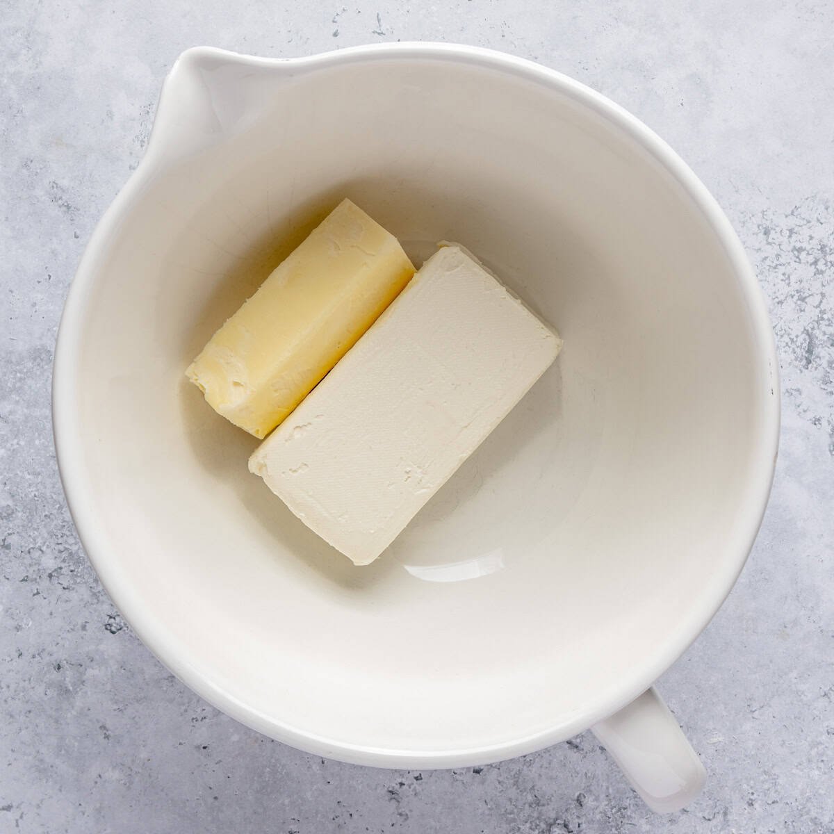 Cream cheese and butter in a bowl.