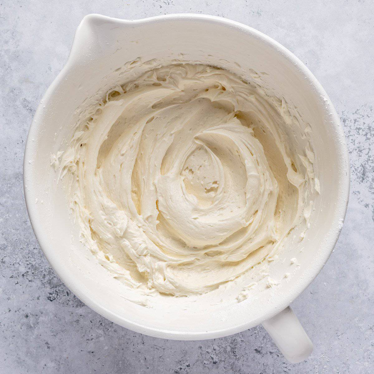 Homemade cream cheese frosting in mixing bowl.