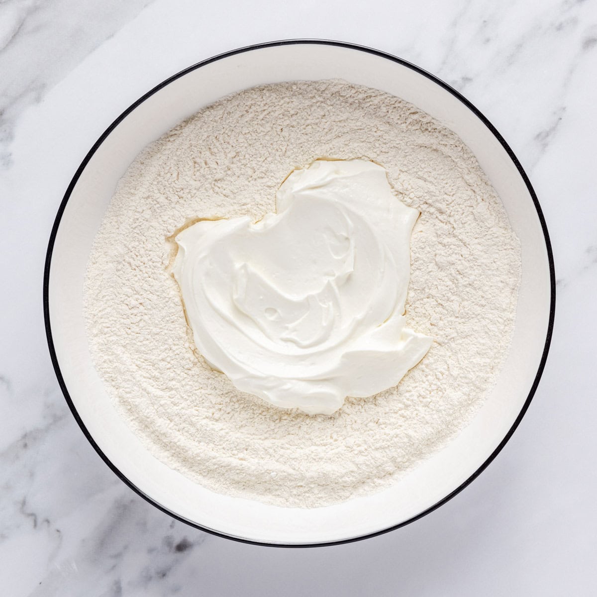 Self-rising flour and yogurt in a bowl.