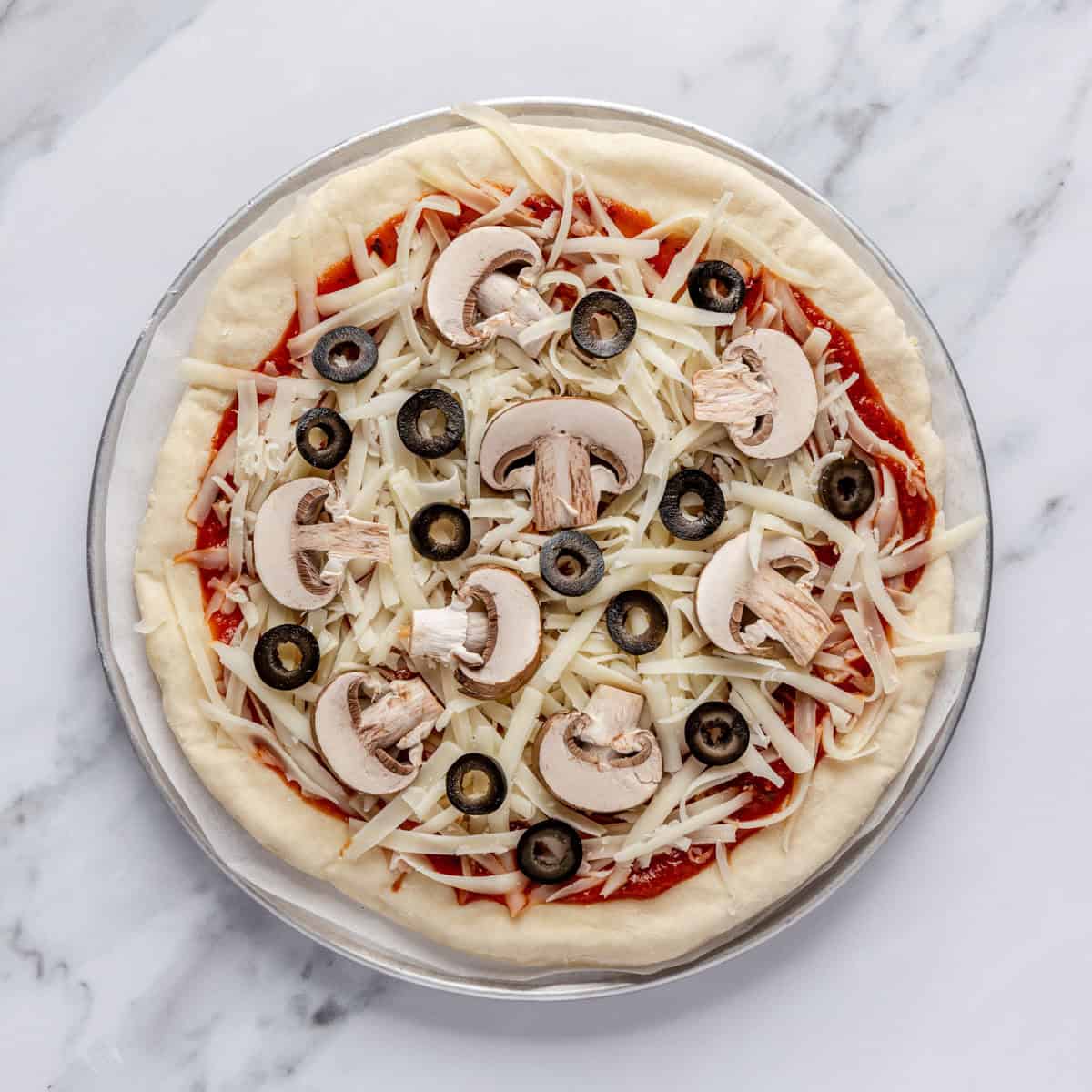 Toppings added to pizza dough.