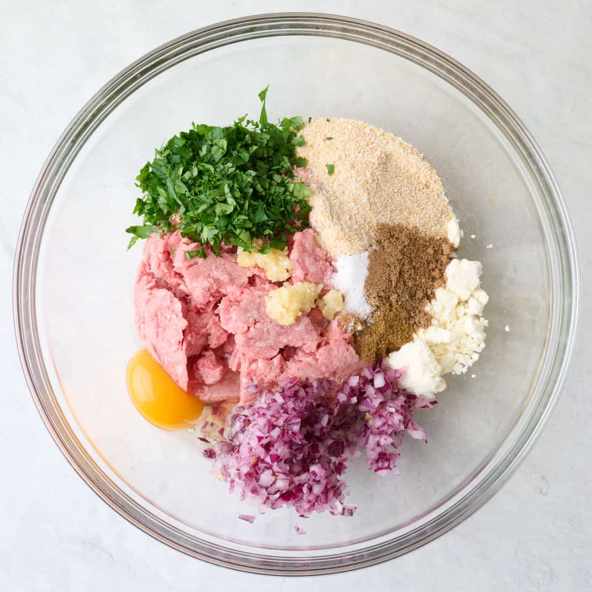 Meatball ingredients in a bowl before mixing.