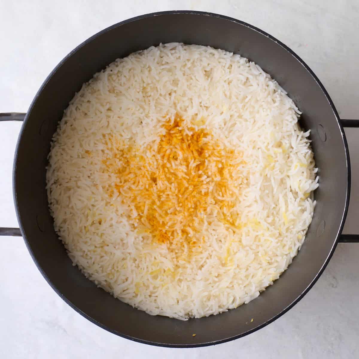 Turmeric sprinkled over cooked rice.