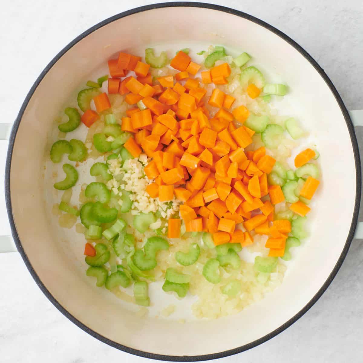 Onions after cooking and translucent with garlic, carrots, celery, and seasonings before cooking.