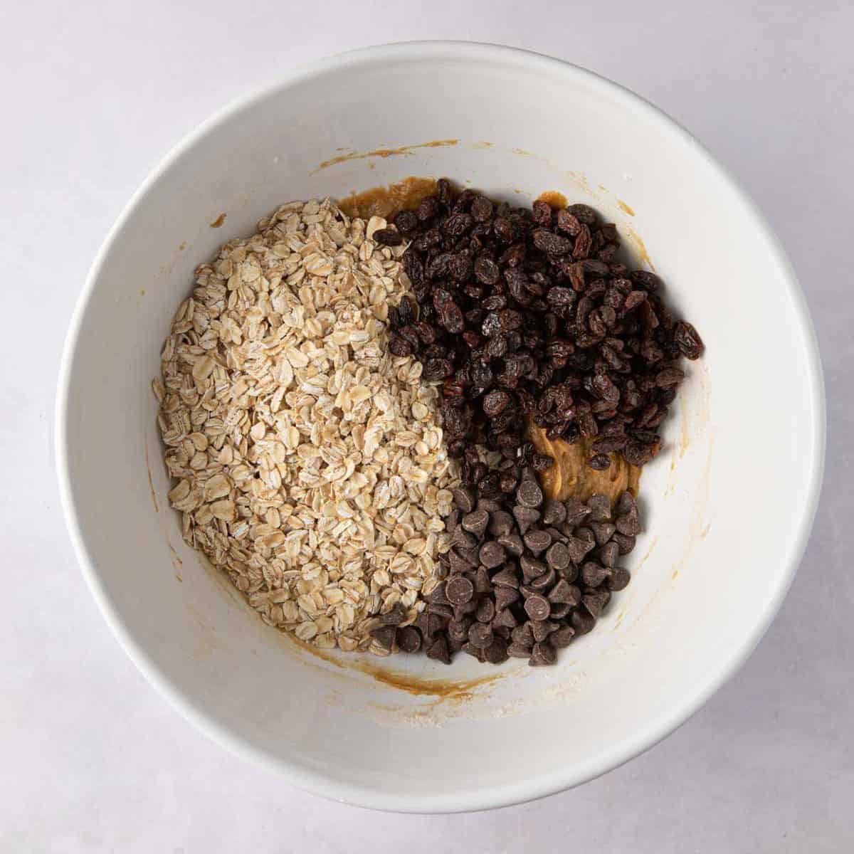 Oats, raisins, and chocolate chips added to cookie dough.