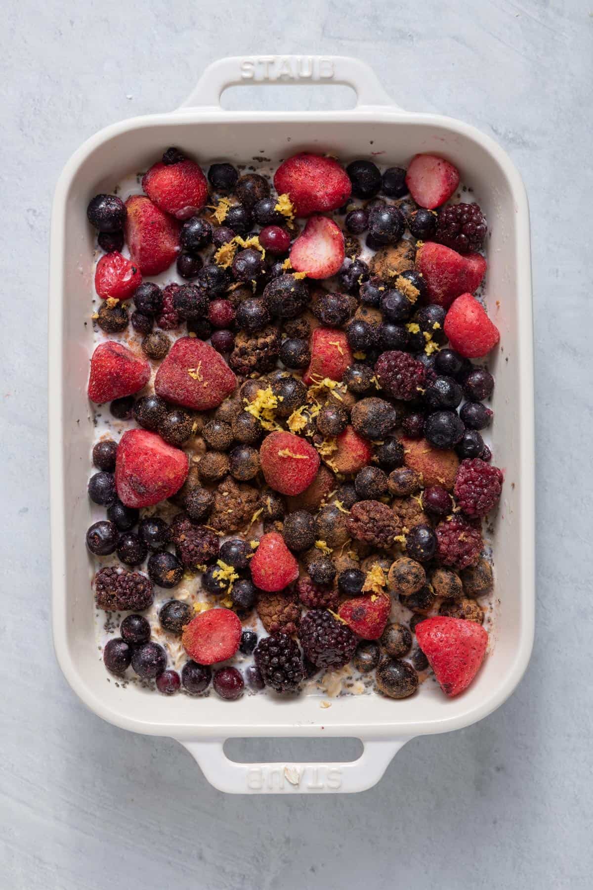 Frozen berries, lemon zest, and cinnamon added on top of oatmeal and berries before baking.