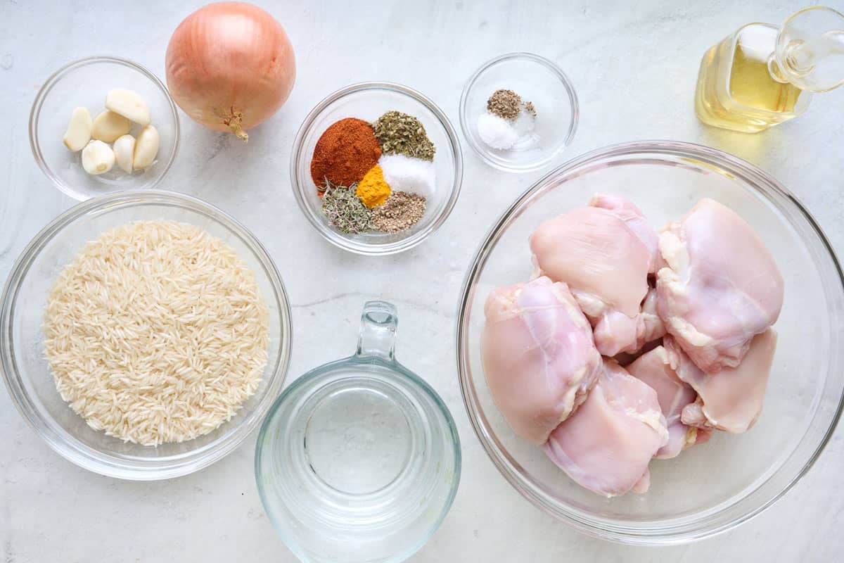 Ingredients for recipe: garlic, basmati rice, onion, spices, water, chicken thighs and oil.