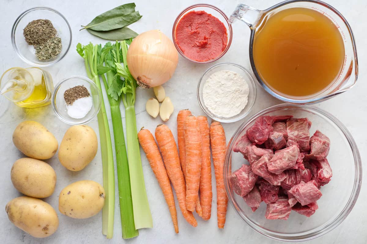 Ingredients for recipe: potatoes, oil, seasonings, celery, onion, garlic, carrots, tomato paste, flour, broth, and beef stew meat.