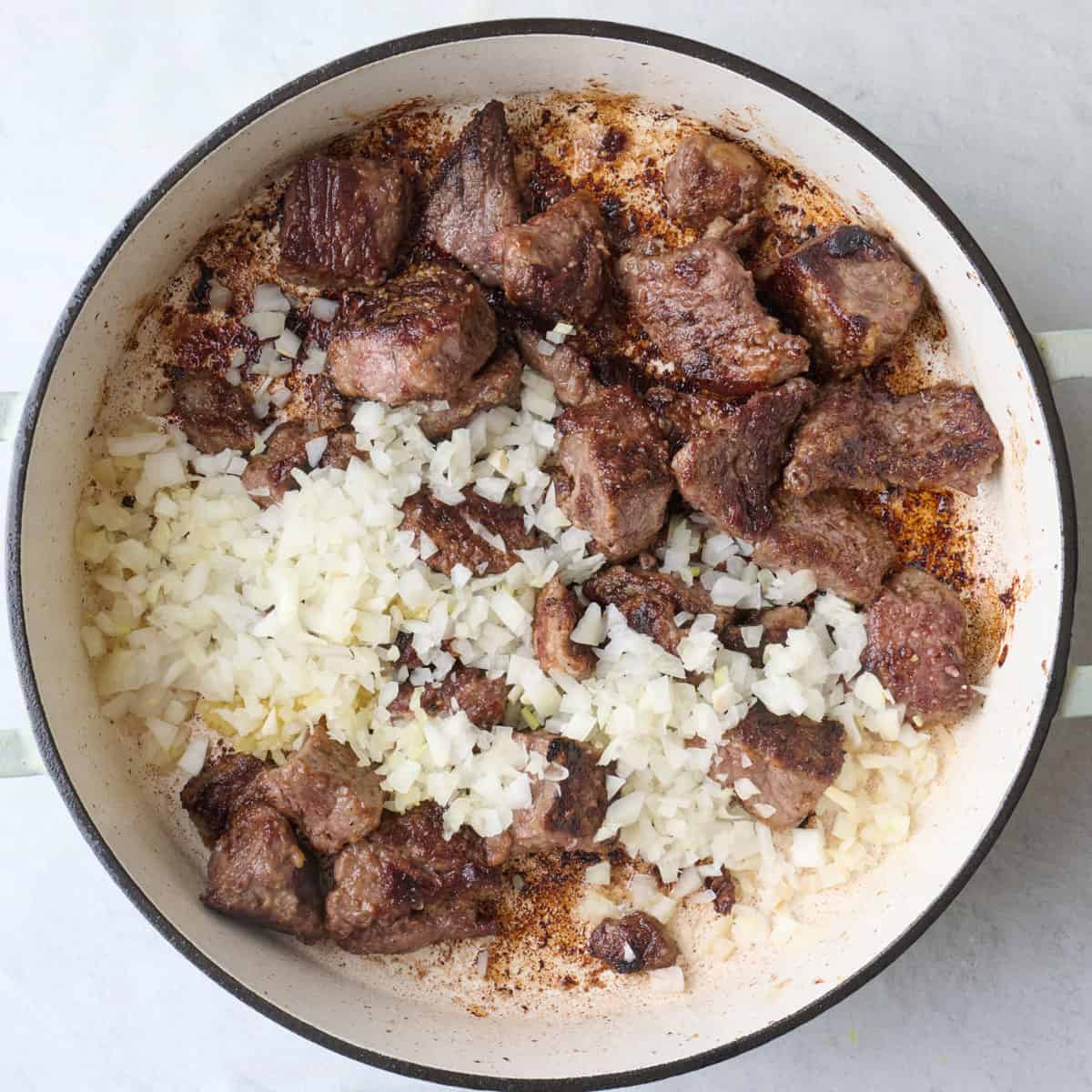 All beef added to pot with onions and garlic.