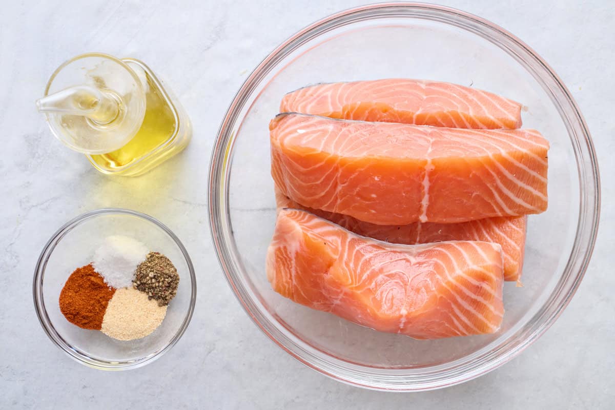 Ingredients for recipe: oil, seasonings, and salmon fillets.