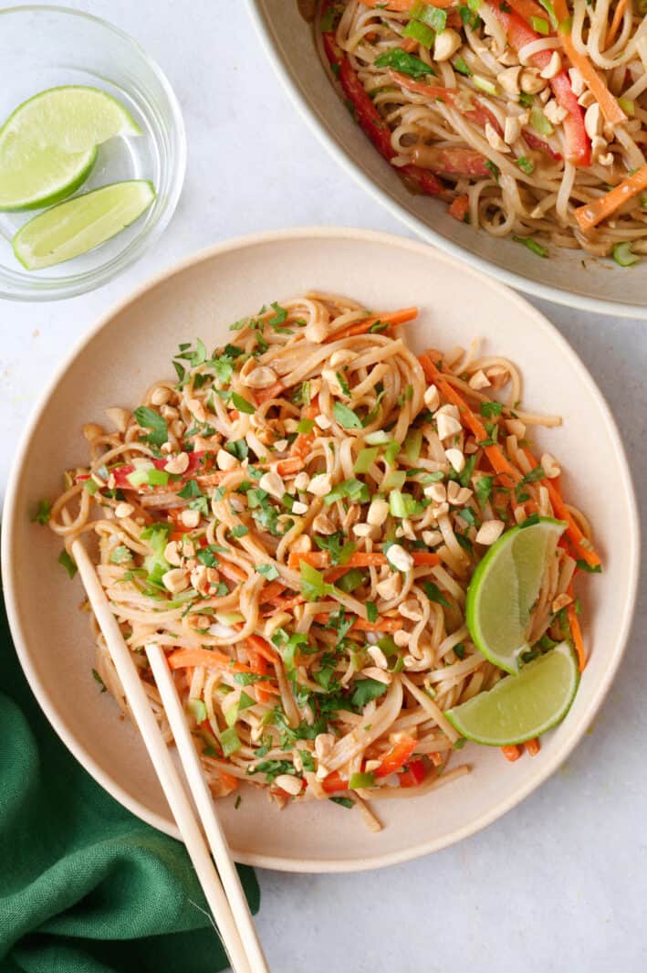 Large serving of salad in a bowl with chop sticks.
