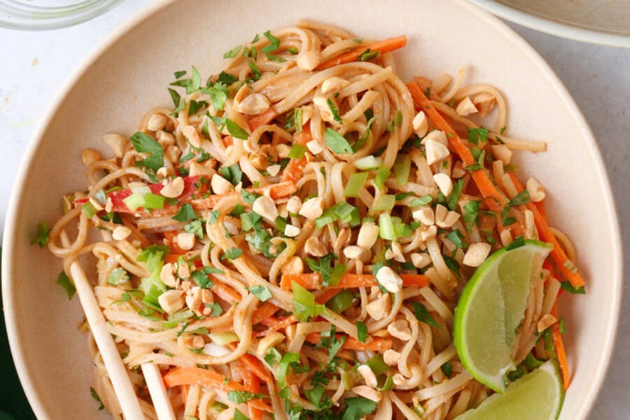 Large serving of salad in a bowl with chop sticks.