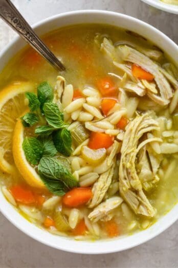 Shredded chicken added top soup and served in bowl.