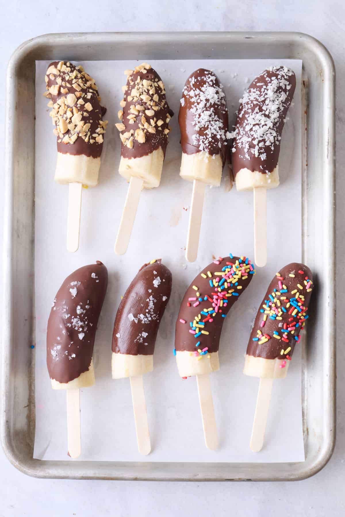 Banana halves with toppings after chocolate has set.