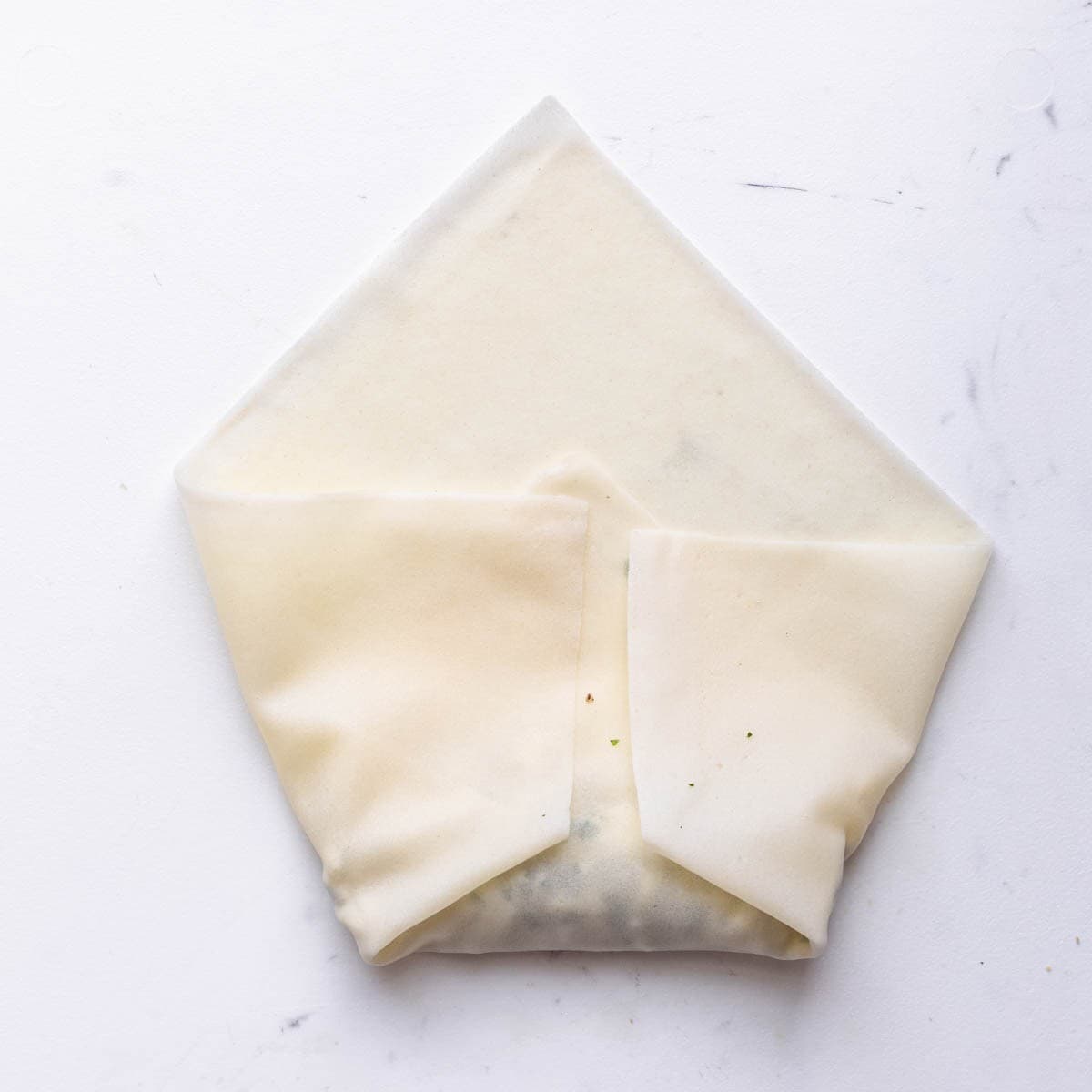 Sides of wrapped folded upwards after bottom fold.