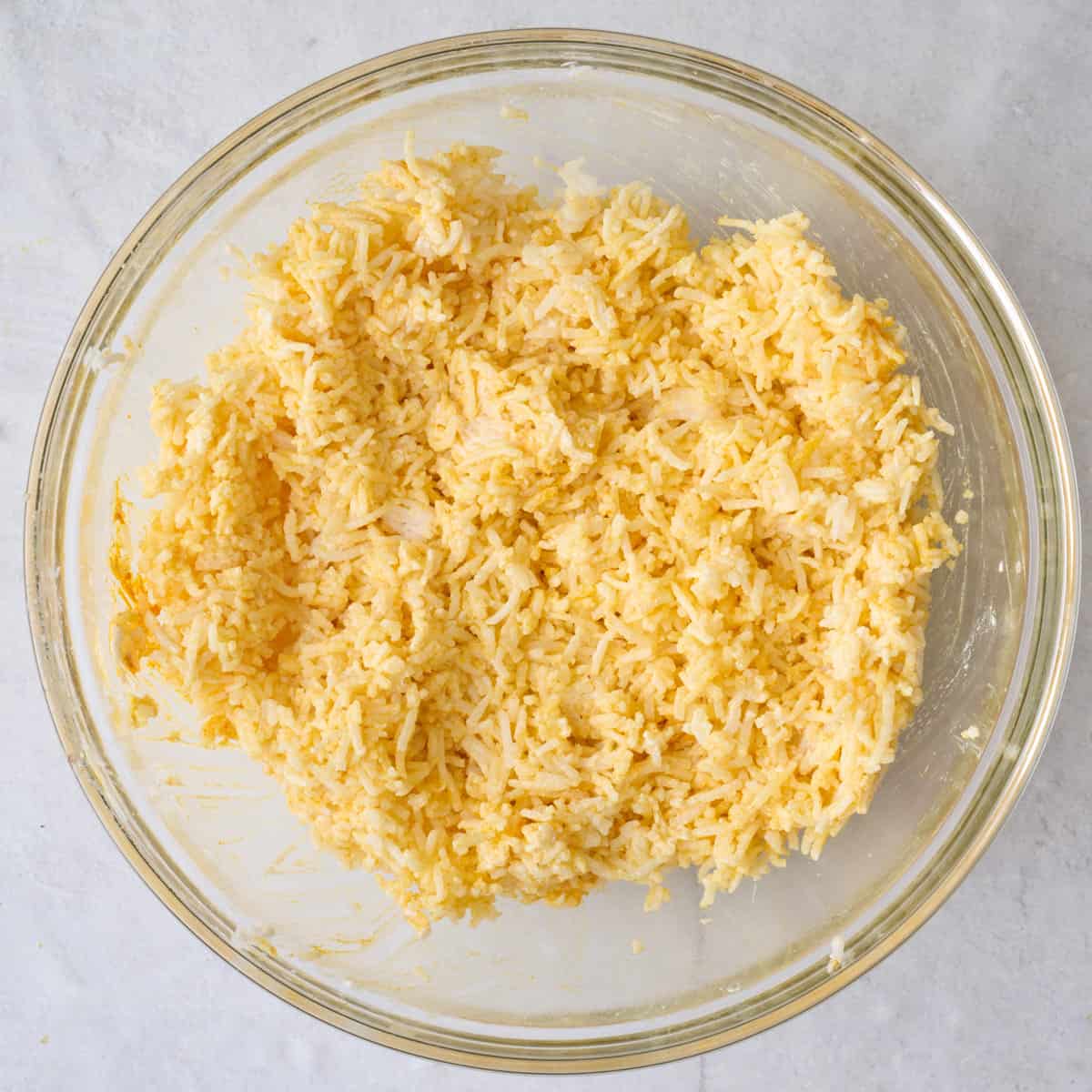 Rice after tossing with yogurt and turmeric.