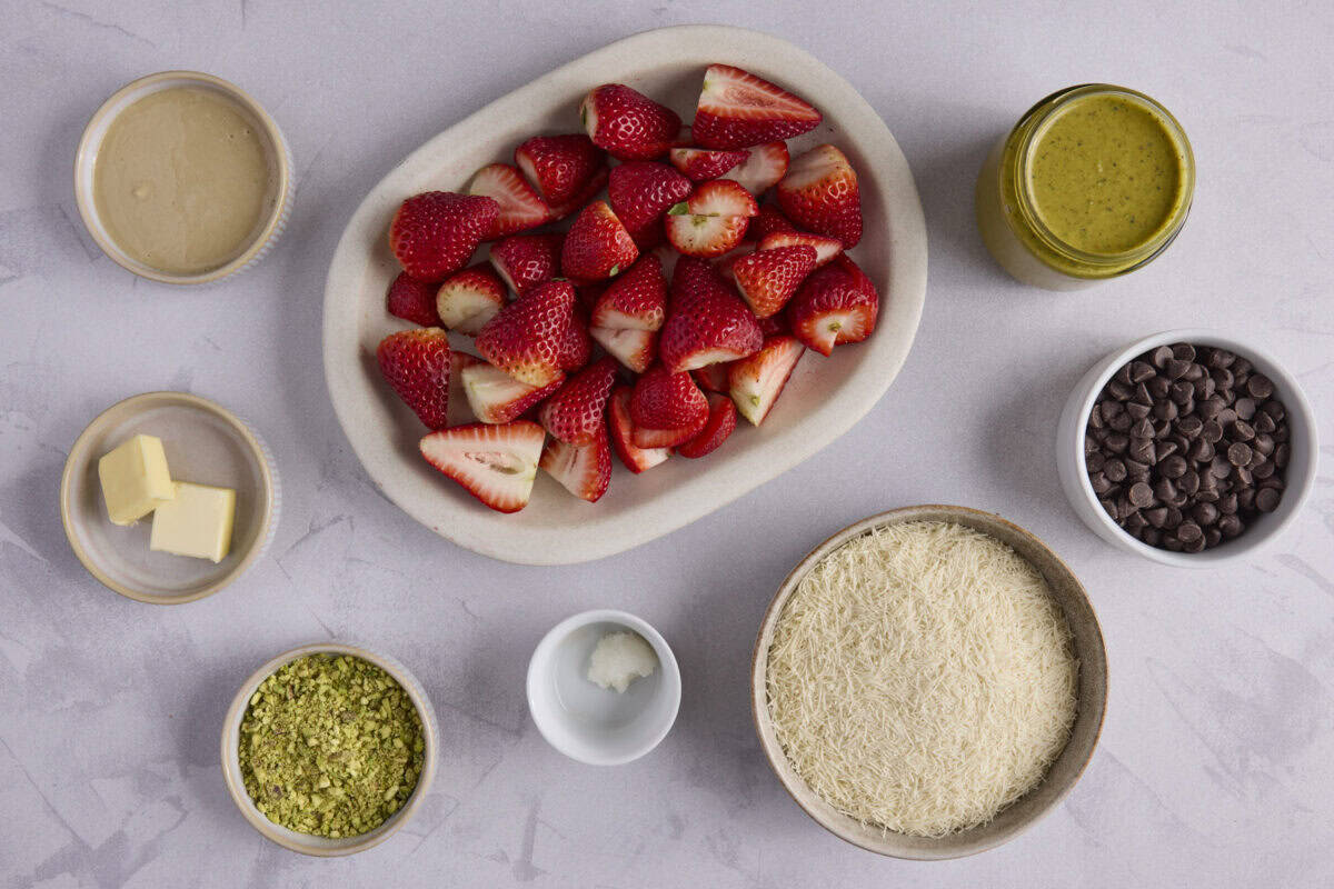 Ingredients for recipe: tahini, butter, crushed pistachios, coconut oil, kataifi, pistachio cream, and chocolate chips.