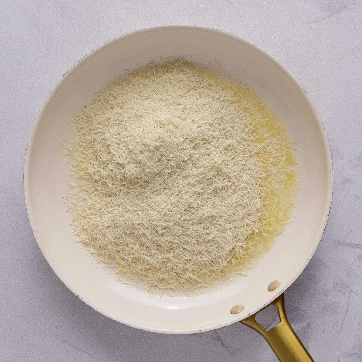 Shredded kataifi dough in a skillet with butter.