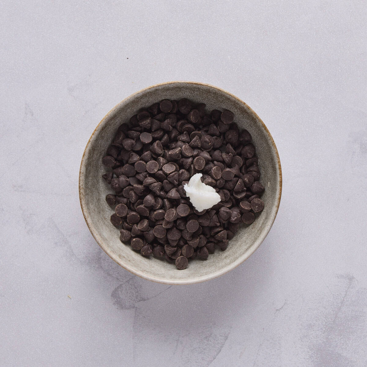 Chocolate chips and coconut oil in a small bowl.