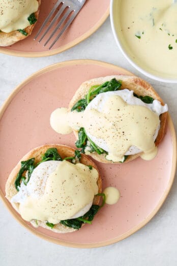 Homemade eggs Florentine on a plate with hollandaise sauce.