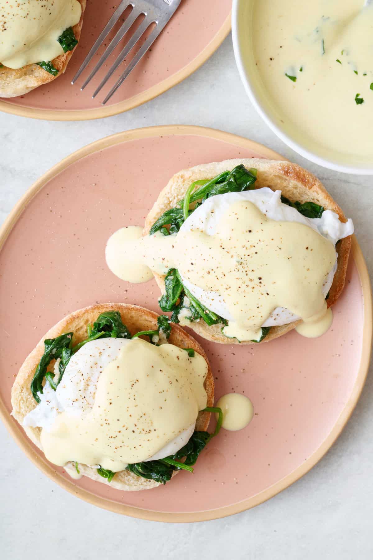 Homemade eggs Florentine on a plate with hollandaise sauce.