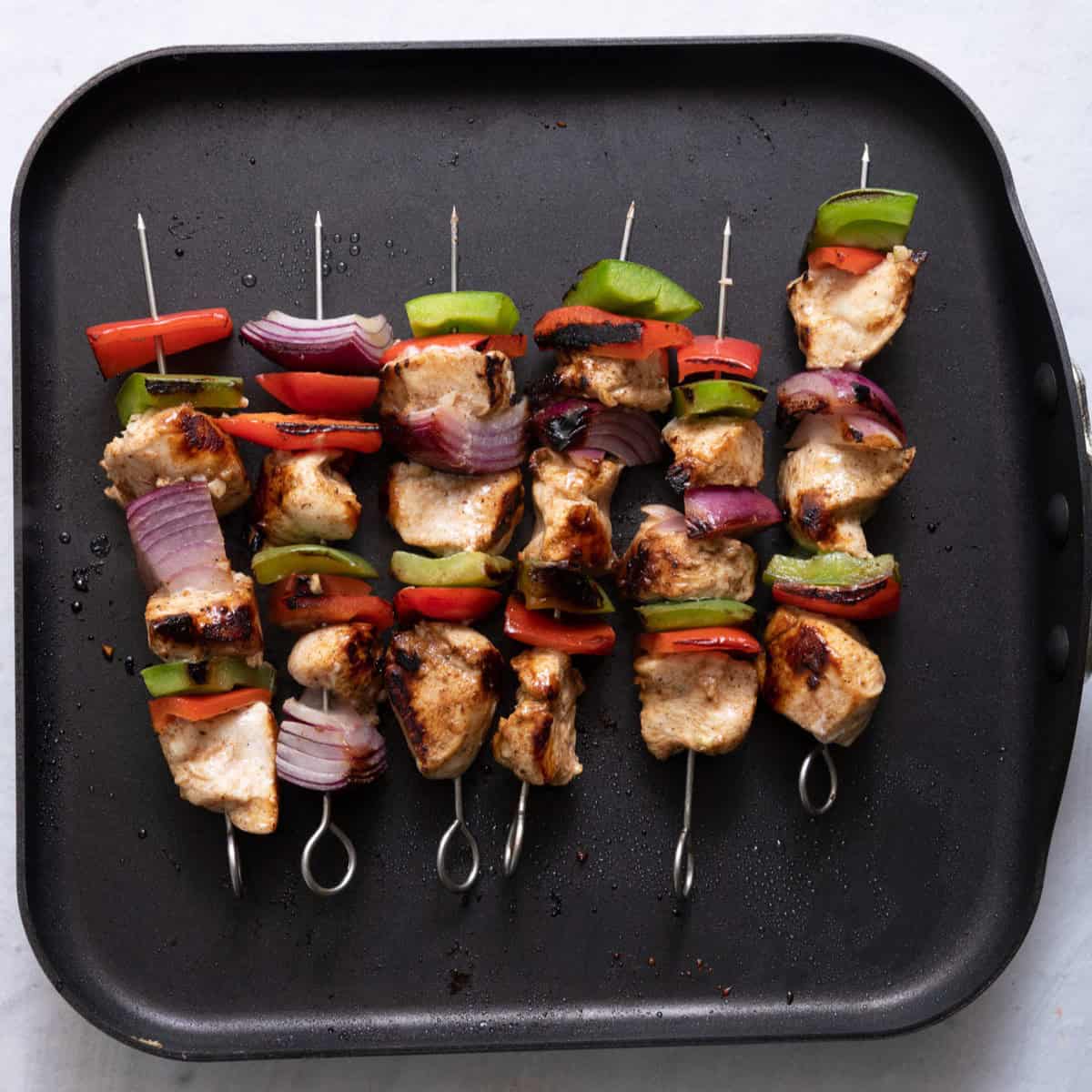 Skewer on grill pan after cooking.