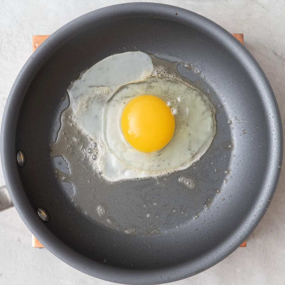 Egg cracked in a skillet.
