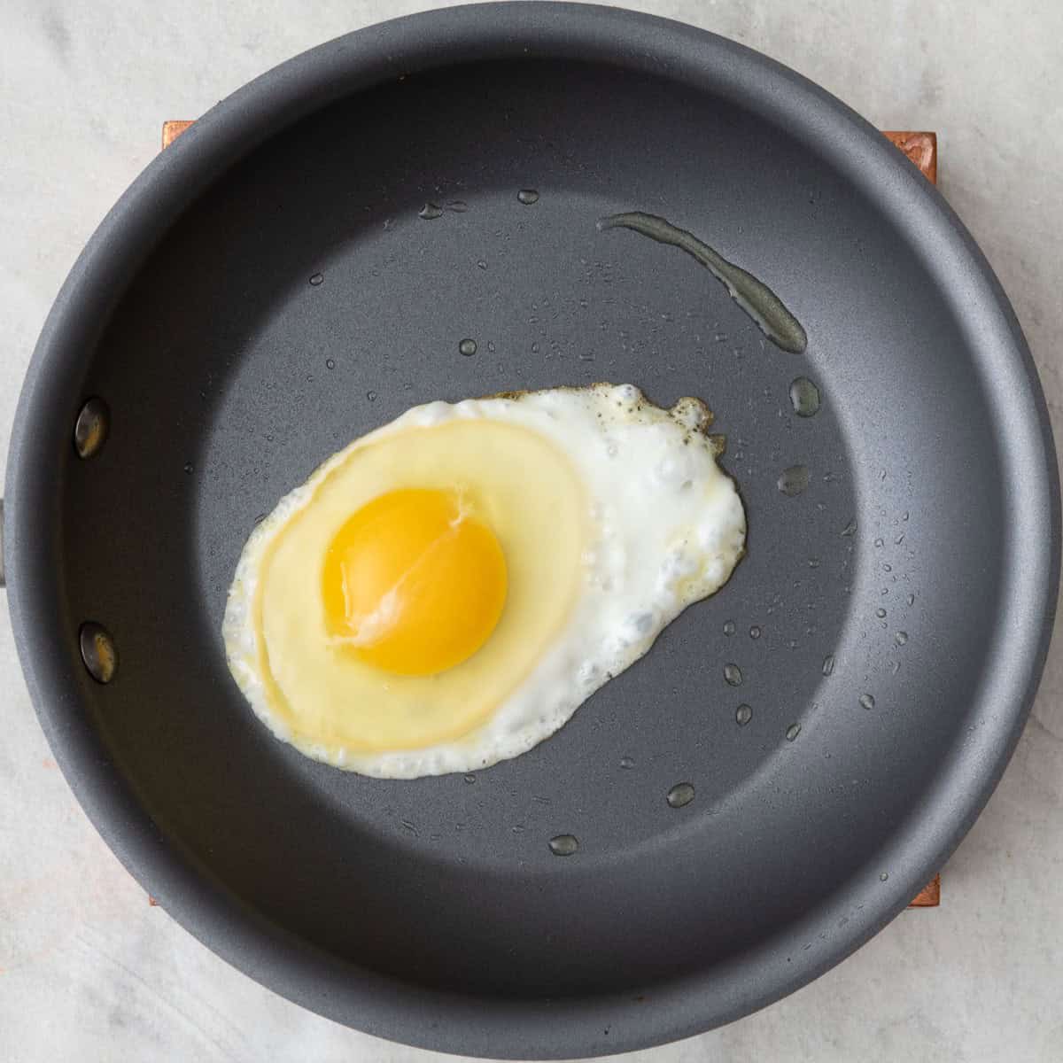 Egg in skillet before flipping for over easy.