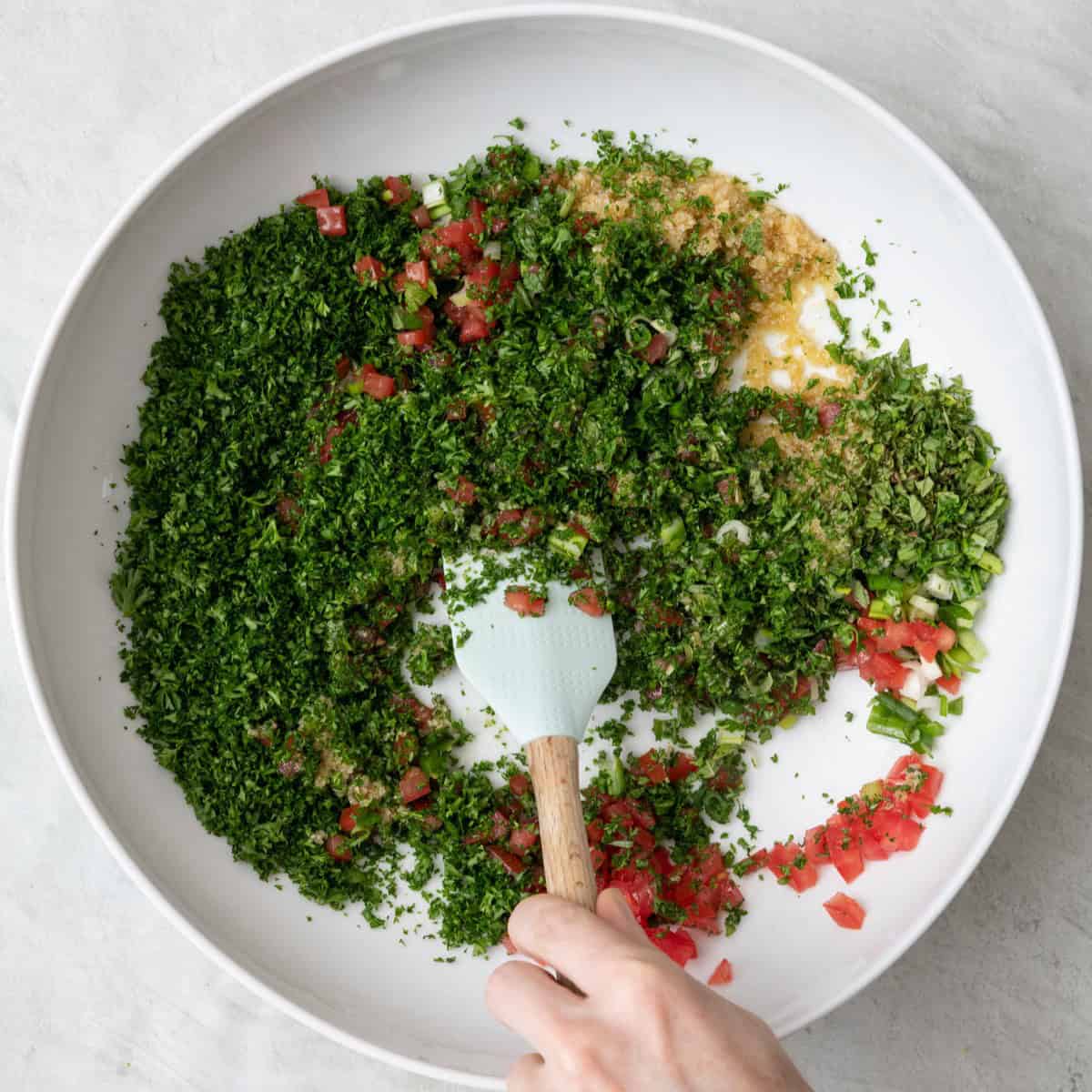 Tossing salad ingredients together.