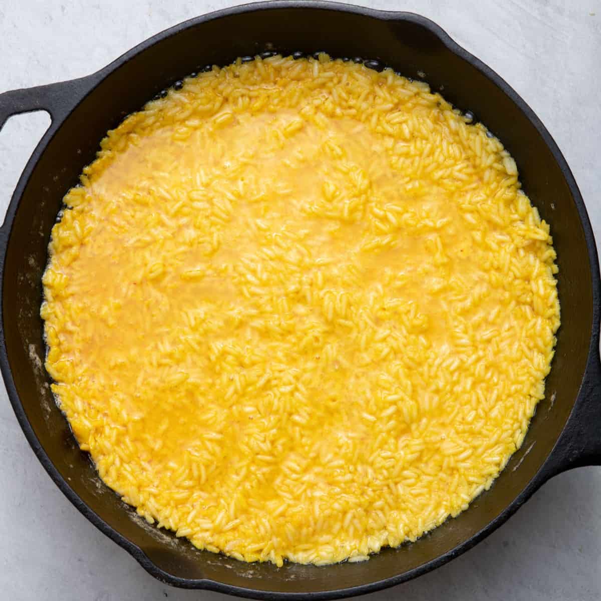 Yogurt rice mixture in cast iron pan.