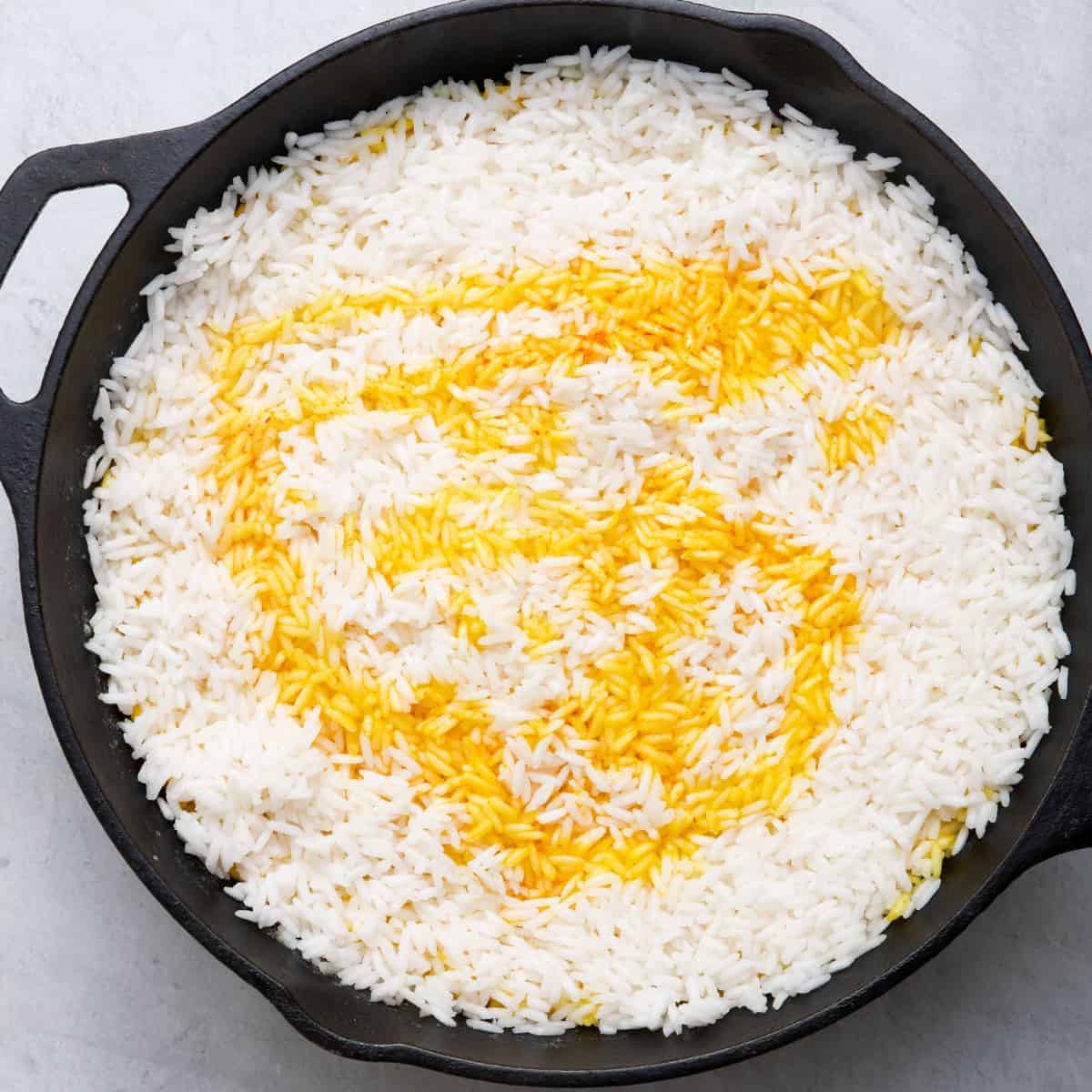 Remaining saffron water drizzled on top of rice.