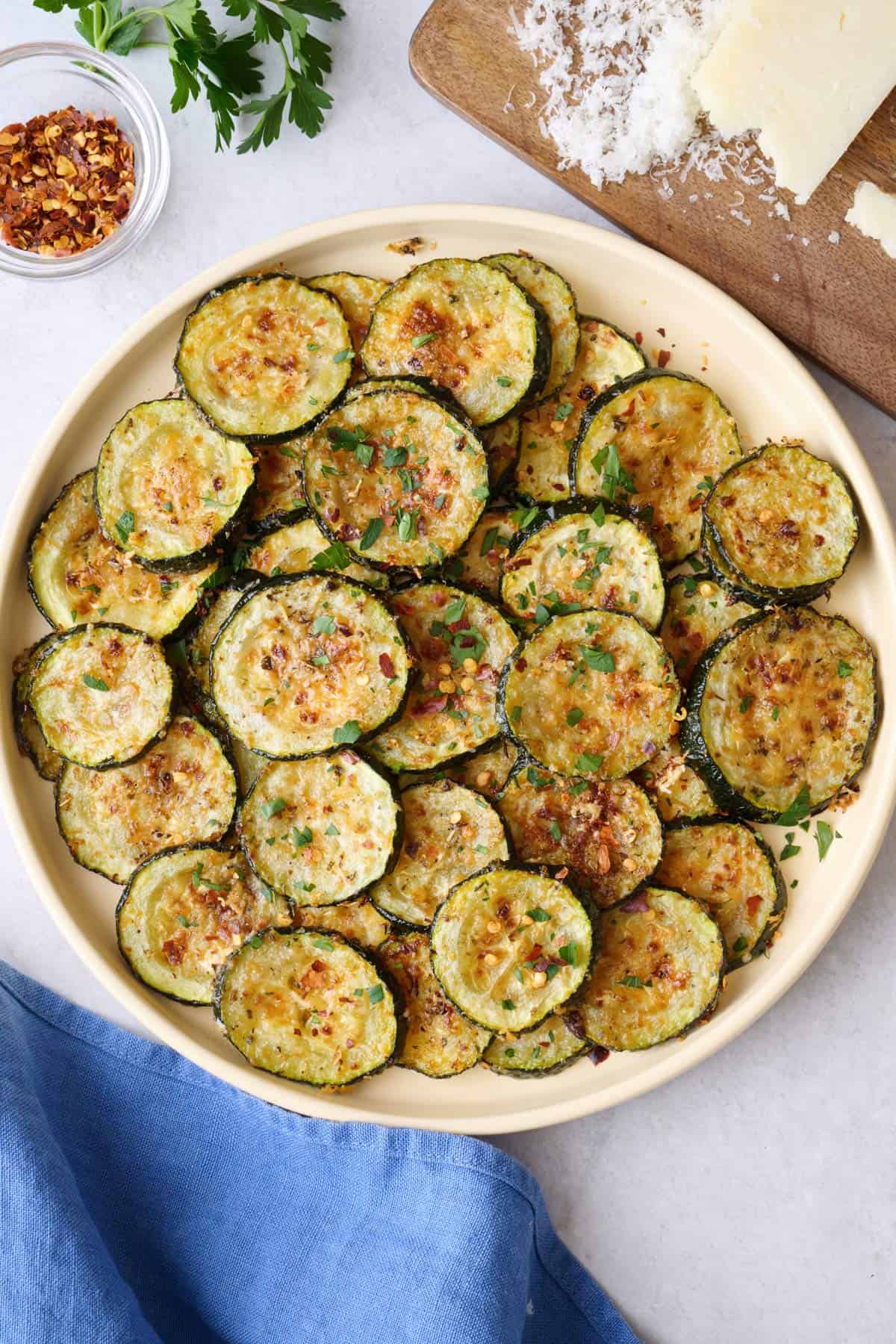 Parmesan roasted zucchini on a serving plate.
