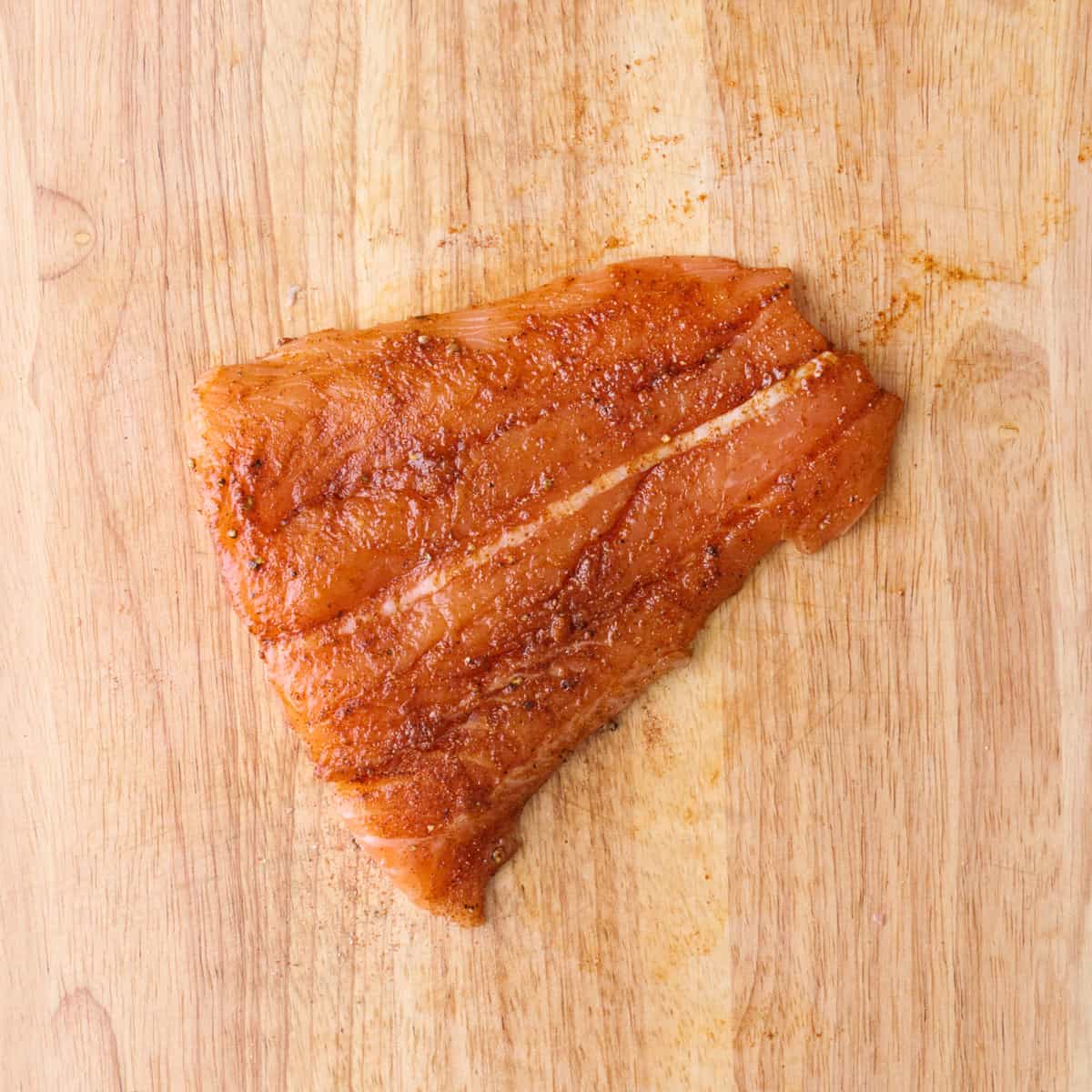 After coating fish in oil and seasoning.