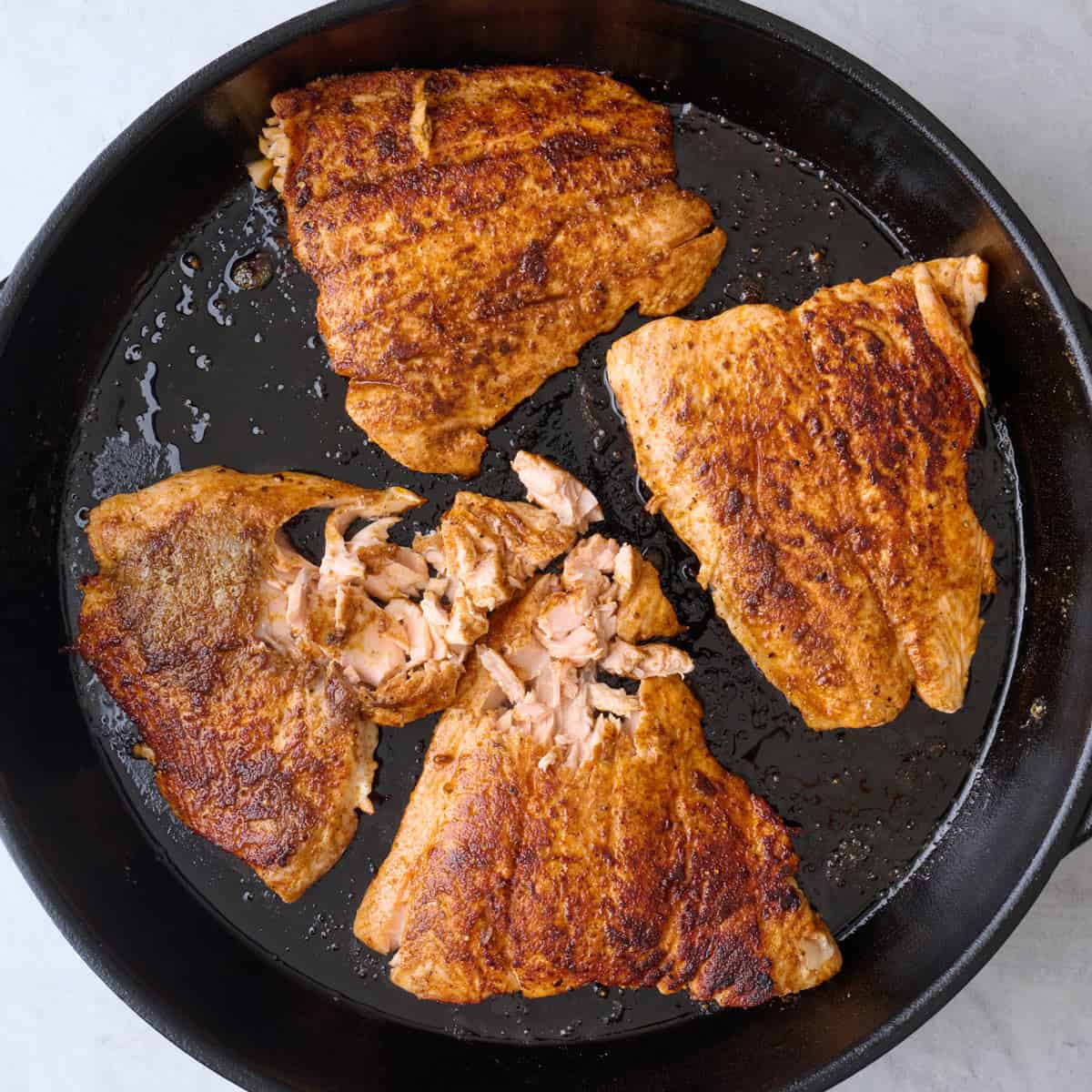 After flipping fish and cooking through with some fish flaked away.