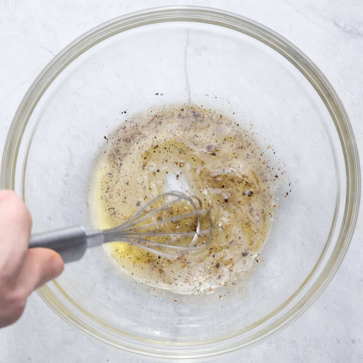 Whisking dressing ingredients.
