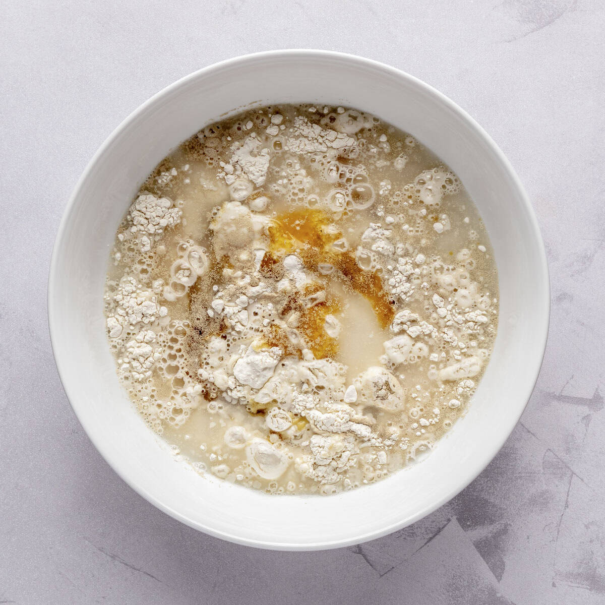 Flour, yeast, salt, water, olive oil, and honey in a large bowl.
