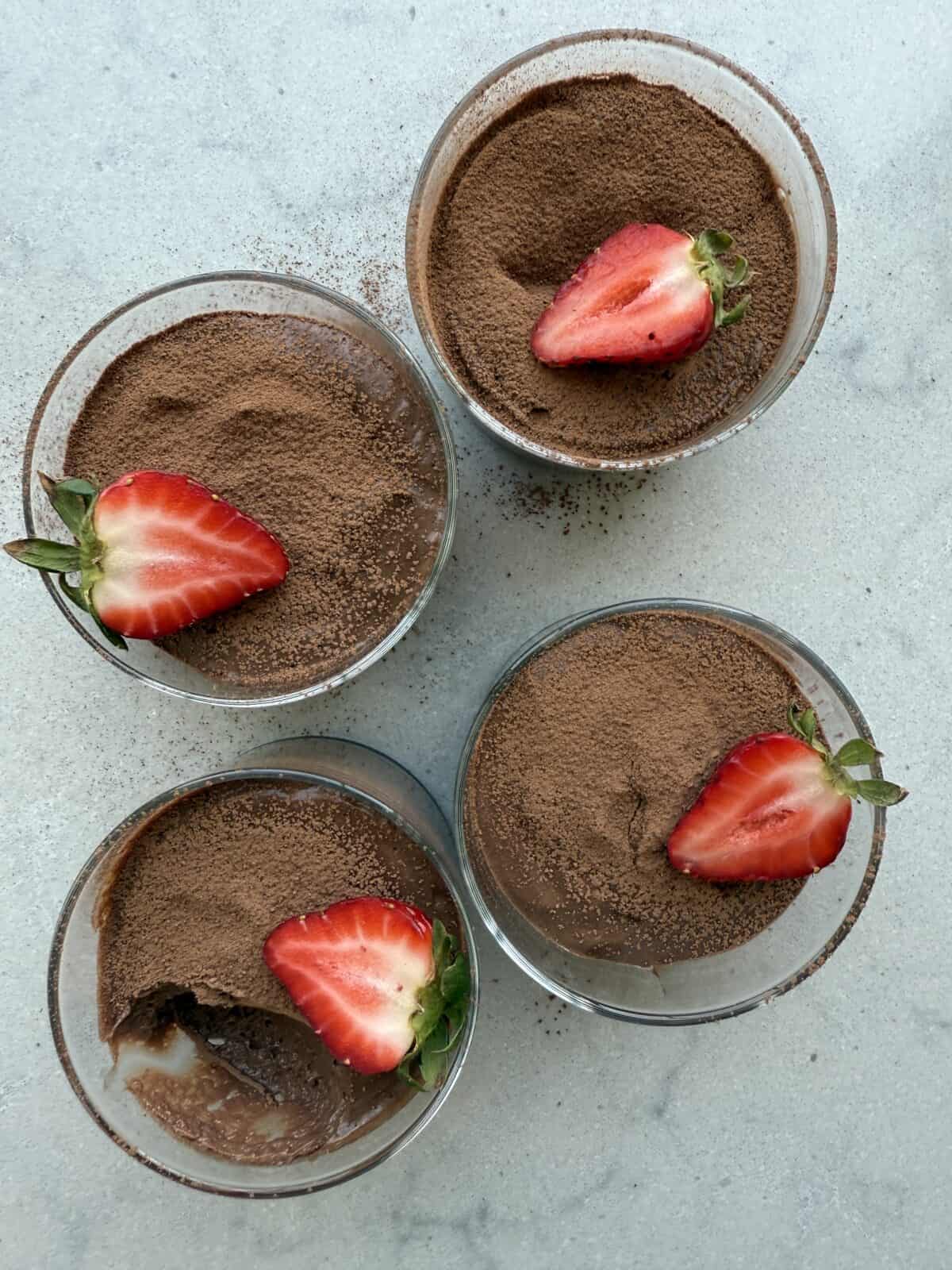 4 bowls of boiled egg chocolate pudding topped with strawberries
