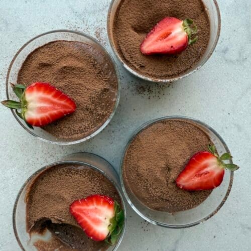 4 bowls of boiled egg chocolate pudding topped with strawberries