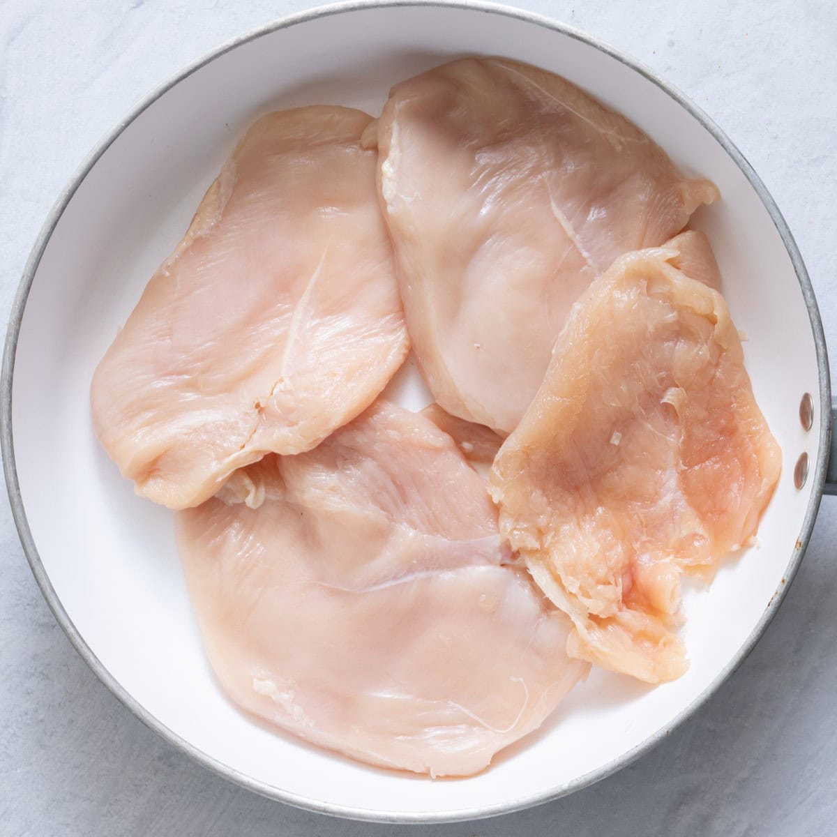Chicken in pan before cooking.