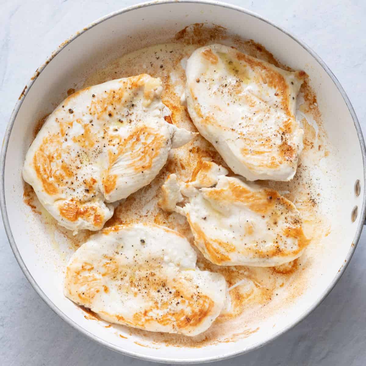 Chicken breasts on pan after cooked.