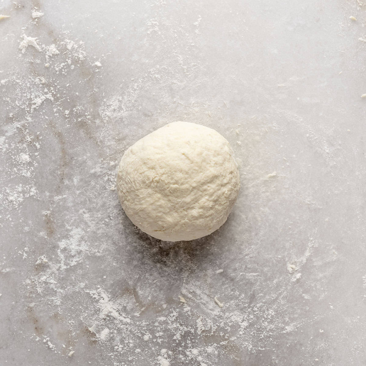 Dough ball on a lightly floured surface after kneading.