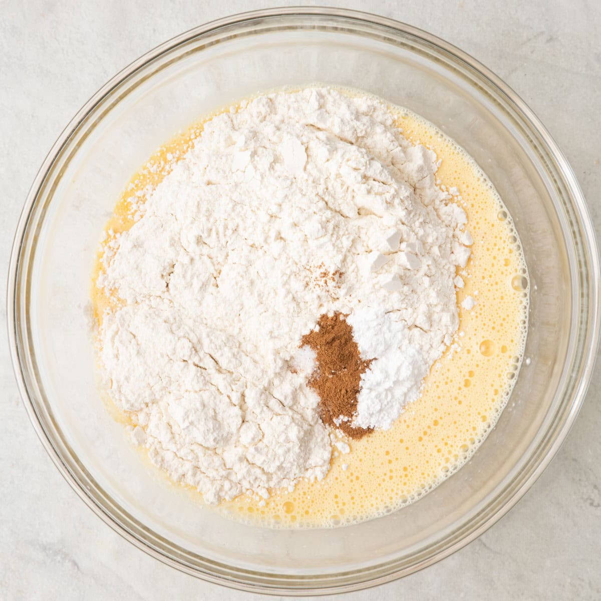 After whisking with with flour, baking powder, cinnamon and salt added on top before combining.