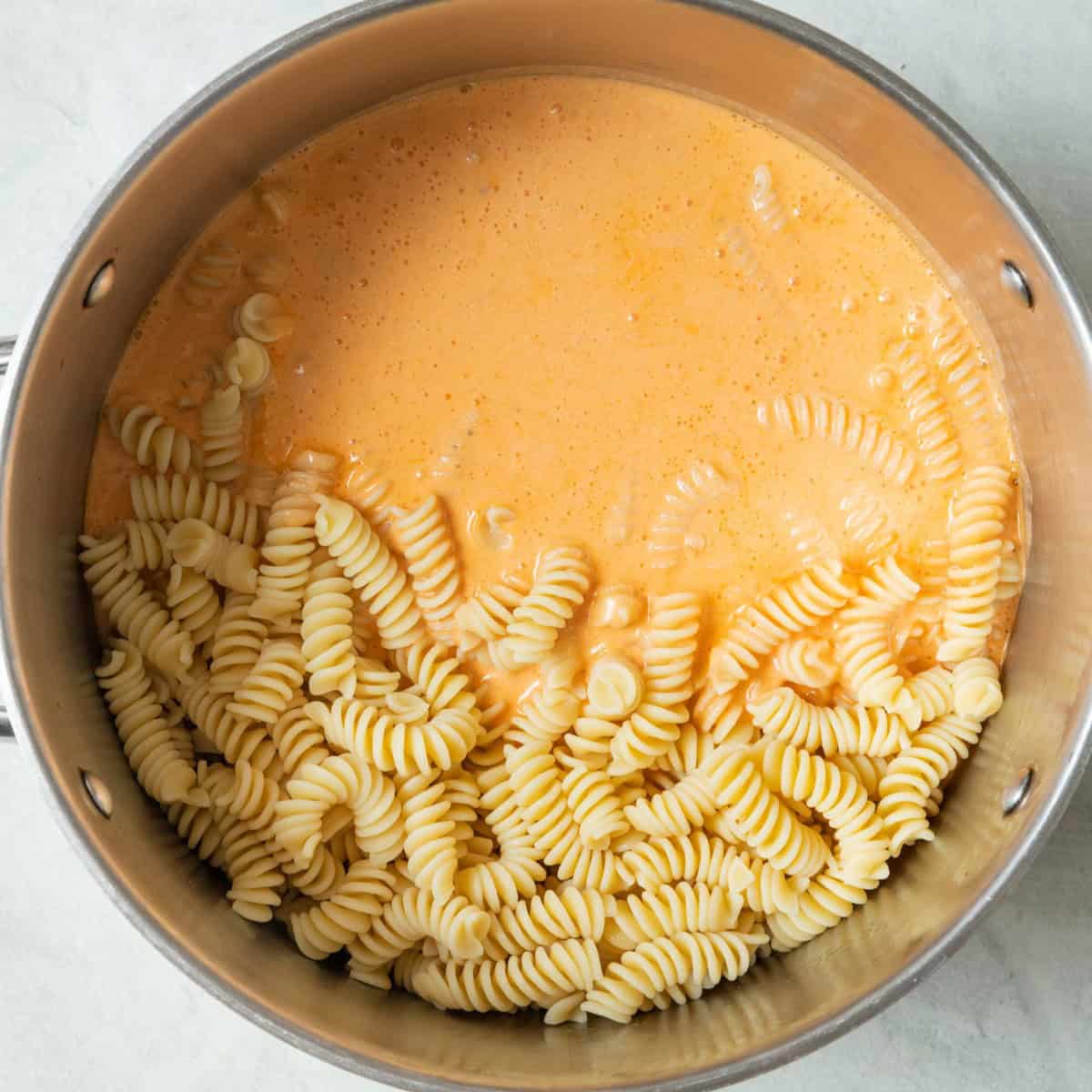 Sauce on top of pasta in pot before combining.