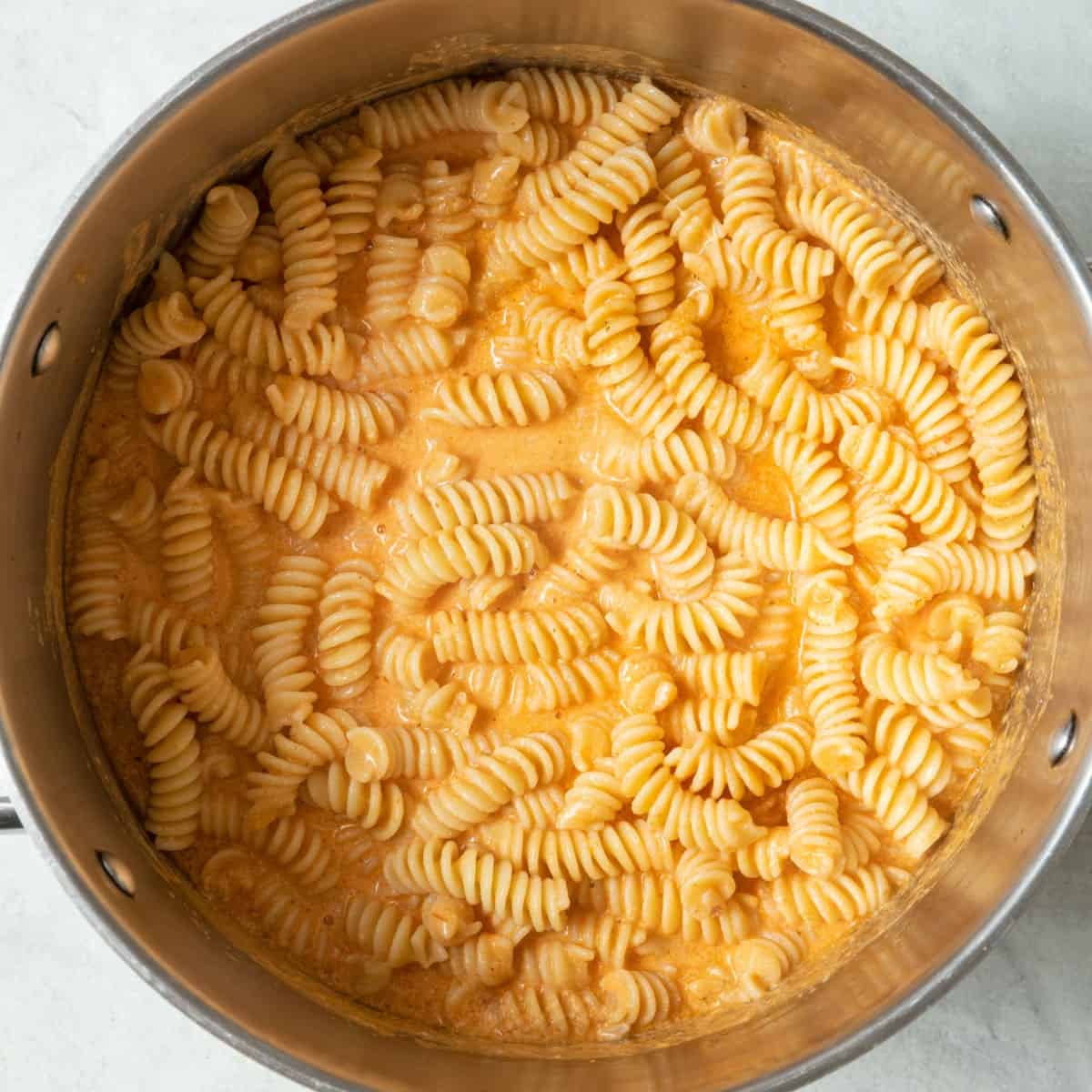 Cooked pasta tossed in sauce.