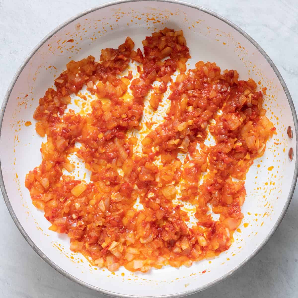 Garlic, harissa and tomato paste cooked with onions.