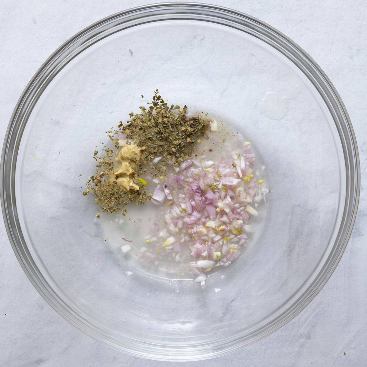 Shallot, lemon juice, dijon mustard and oregano in the bottom of large shallow bowl.