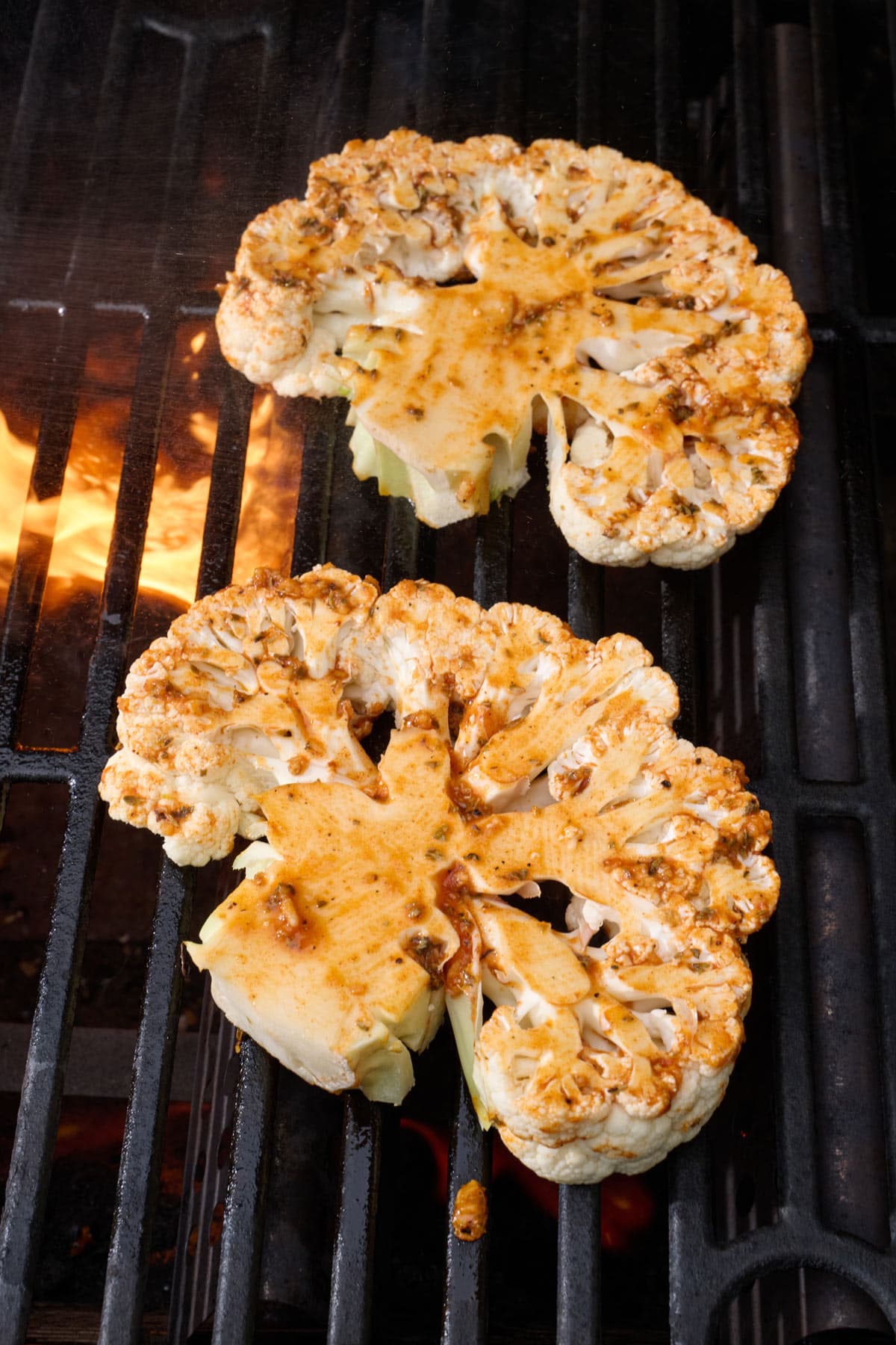 Cauliflower steaks on grill.