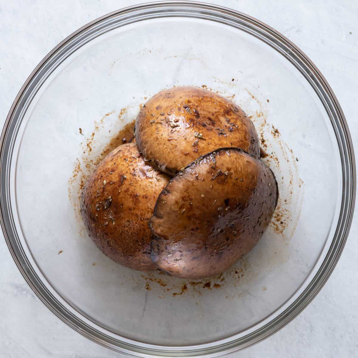 Portobello mushrooms tossed in marinade.
