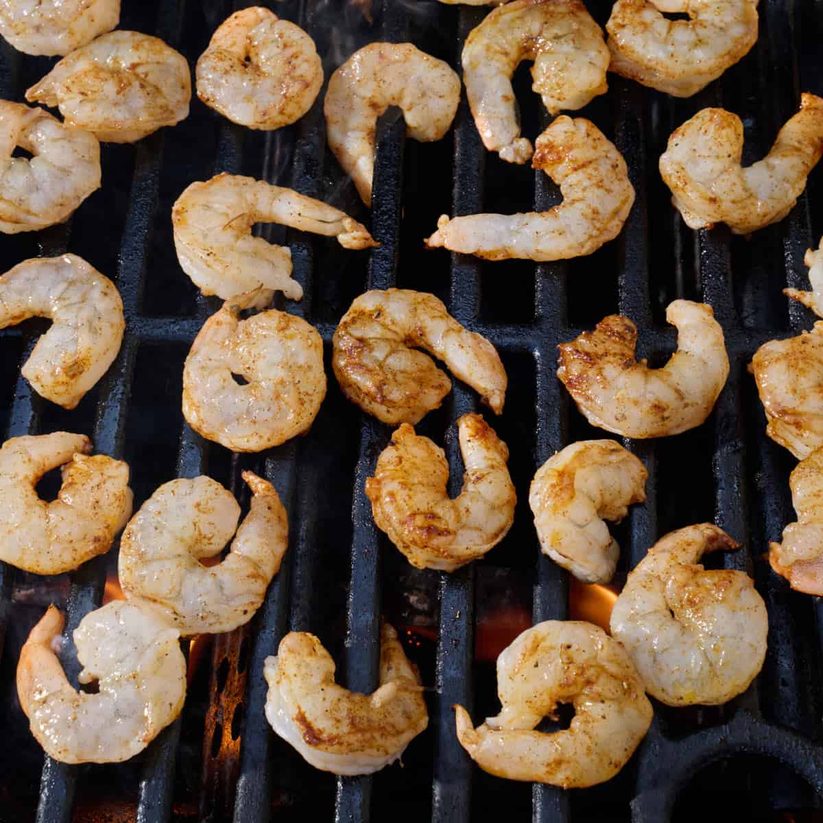 Seasoned shrimp on an outdoor grill.